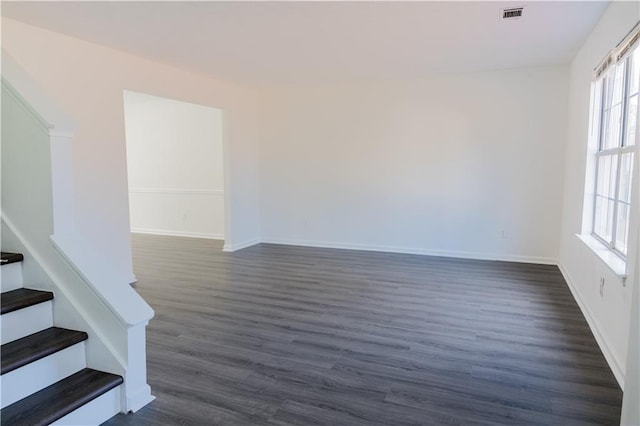 unfurnished room featuring dark hardwood / wood-style flooring