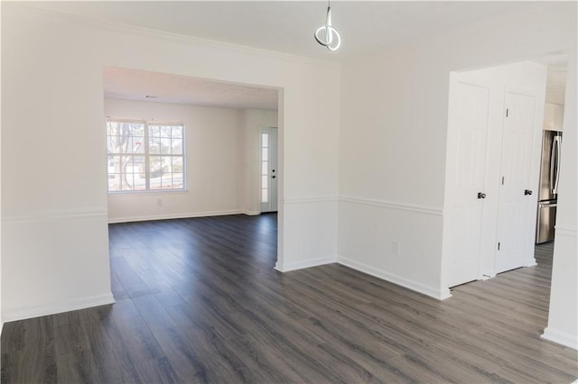 unfurnished room with crown molding and dark hardwood / wood-style flooring