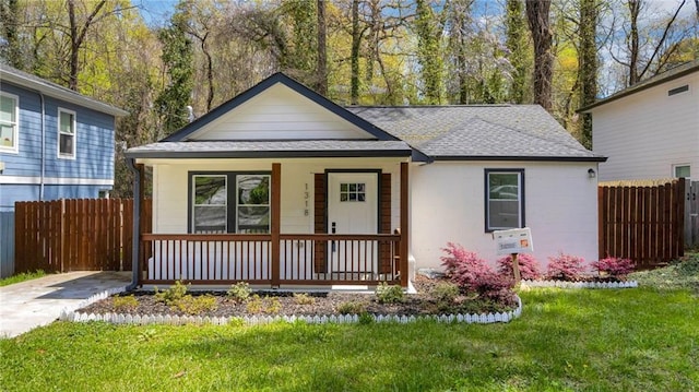 view of front of home with a front yard and a porch