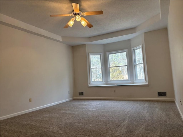 unfurnished room featuring carpet, visible vents, and baseboards