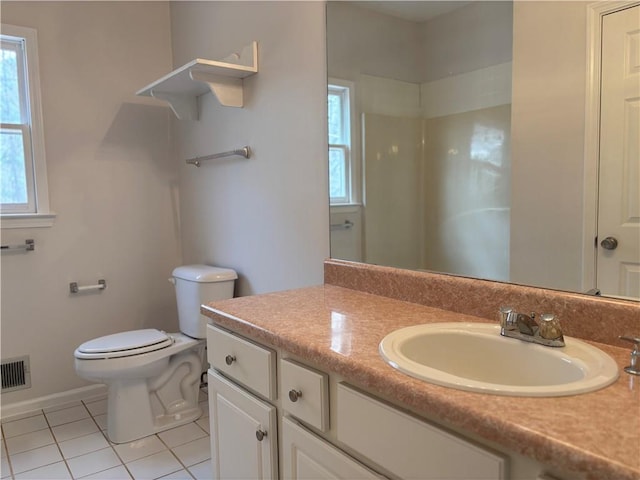 bathroom with visible vents, toilet, vanity, tile patterned flooring, and baseboards