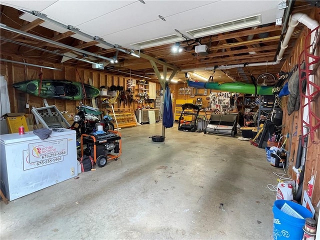 655 Chester Harris Dr, Dallas, GA 30132 - garage featuring a workshop area and a garage door opener