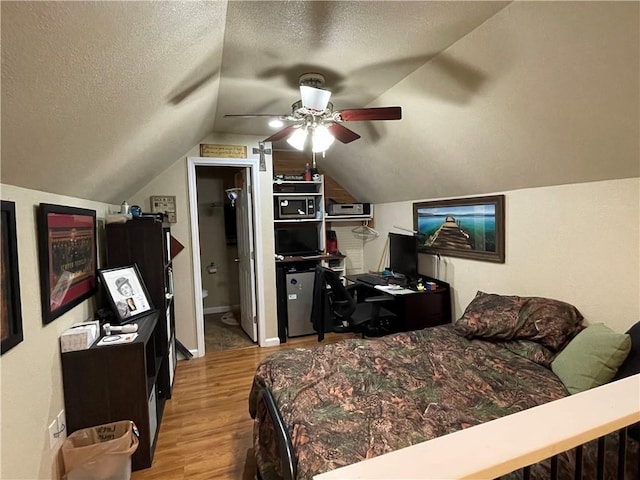 655 Chester Harris Dr, Dallas, GA 30132 - bedroom with a textured ceiling, wood finished floors, lofted ceiling, and ceiling fan