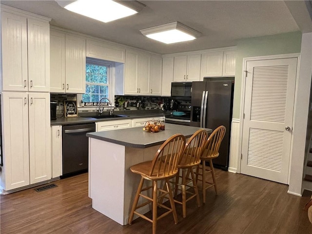655 Chester Harris Dr, Dallas, GA 30132 - kitchen with dishwasher, stainless steel refrigerator with ice dispenser, a sink, dark countertops, and black microwave