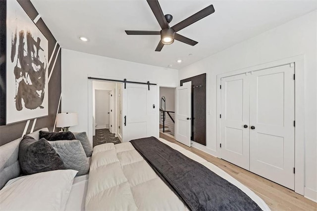 701 Pryor St SW Unit 5, Atlanta, GA 30315 - bedroom with light wood finished floors, a barn door, recessed lighting, a ceiling fan, and baseboards