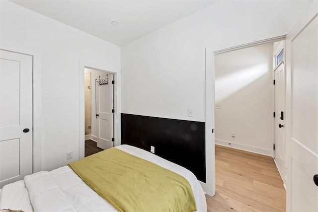 701 Pryor St SW Unit 5, Atlanta, GA 30315 - bedroom featuring wood finished floors, baseboards, vaulted ceiling, and connected bathroom