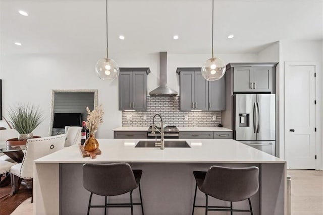 701 Pryor St SW Unit 5, Atlanta, GA 30315 - kitchen featuring wall chimney range hood, stainless steel refrigerator with ice dispenser, gray cabinets, a sink, and light countertops