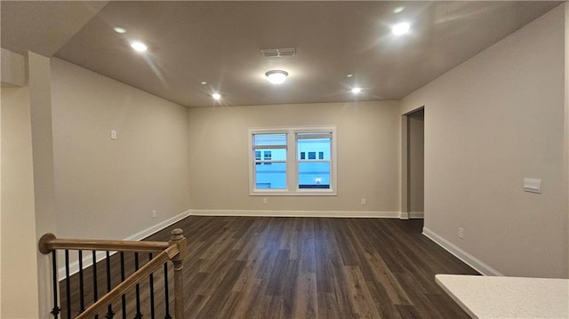 spare room with dark hardwood / wood-style flooring