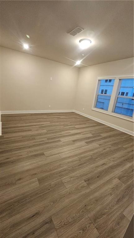 spare room with dark hardwood / wood-style flooring