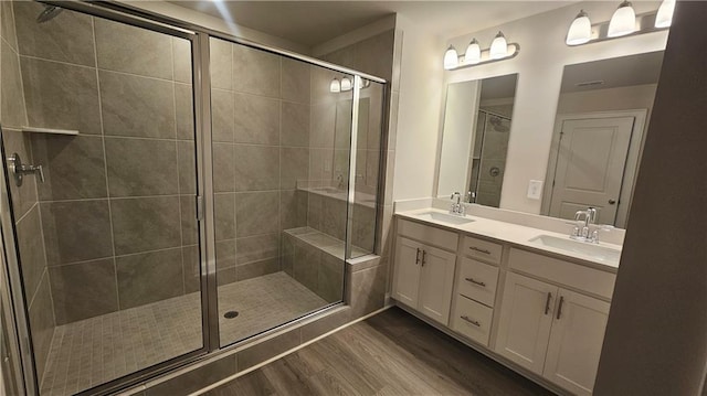 bathroom featuring walk in shower, hardwood / wood-style floors, and vanity