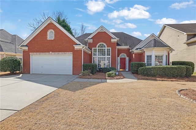 traditional home featuring concrete driveway and brick siding