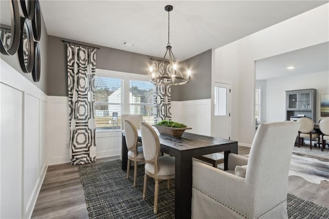 dining space with a chandelier and hardwood / wood-style flooring