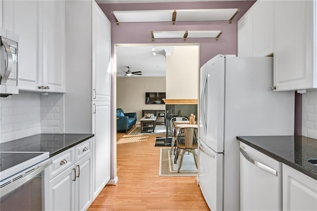 kitchen with dishwashing machine, tasteful backsplash, white cabinetry, and ceiling fan