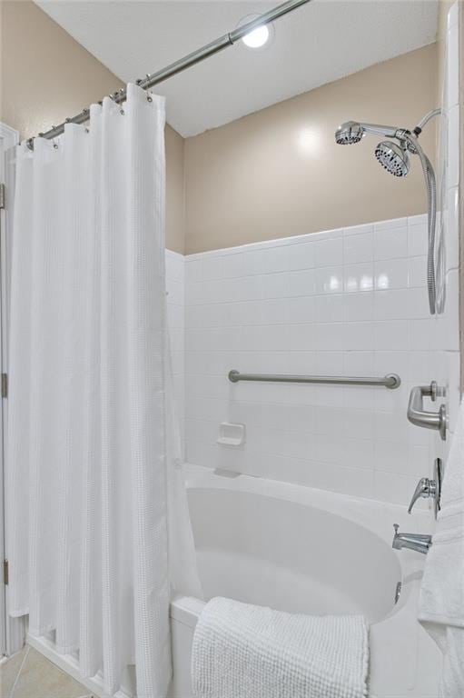 bathroom with shower / bathtub combination with curtain