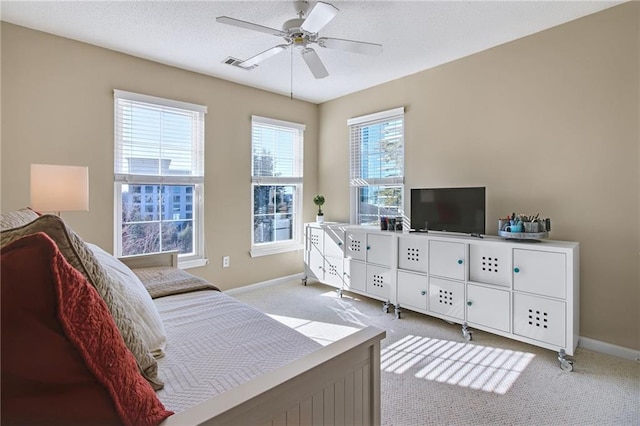 interior space with ceiling fan and a textured ceiling