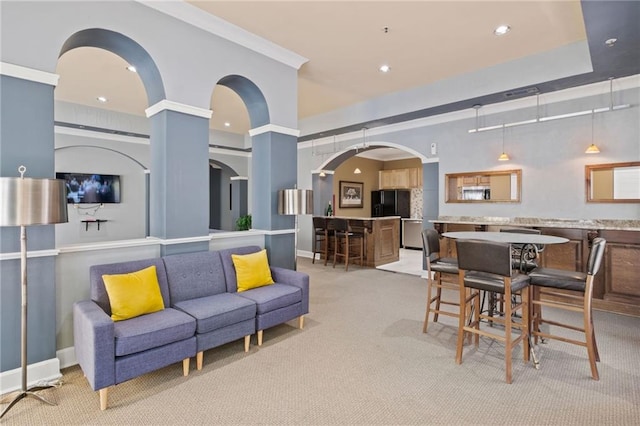 living room with light colored carpet and ornamental molding