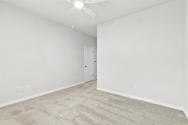 empty room with a ceiling fan, baseboards, and carpet flooring