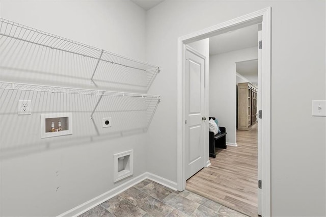 clothes washing area with baseboards, laundry area, washer hookup, and hookup for an electric dryer