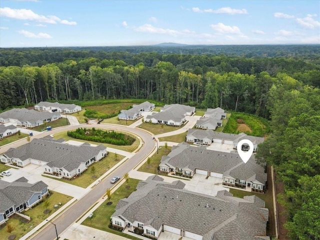 birds eye view of property featuring a forest view and a residential view