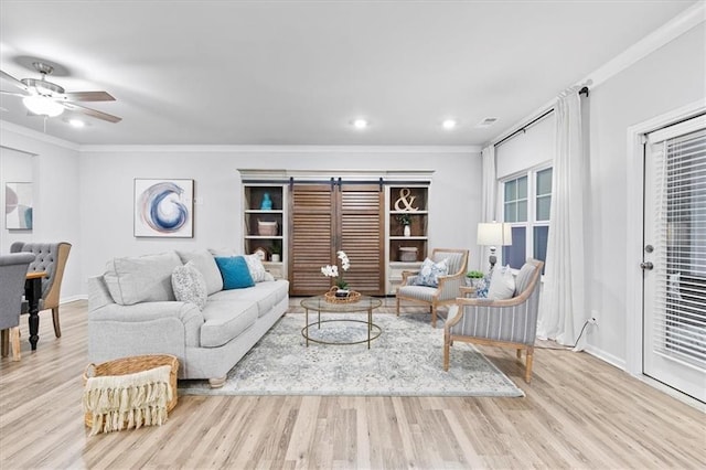 living room featuring ceiling fan, baseboards, wood finished floors, and crown molding