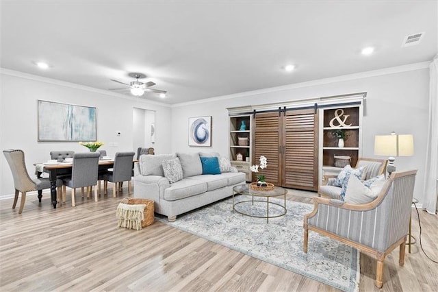 living room with ceiling fan, recessed lighting, wood finished floors, visible vents, and crown molding