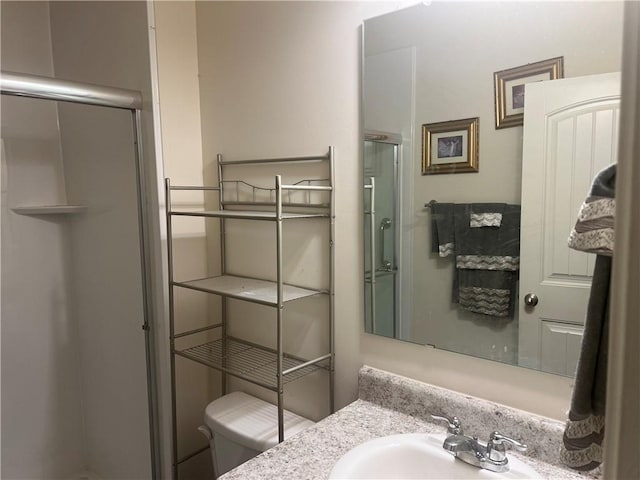 bathroom featuring vanity, toilet, and an enclosed shower