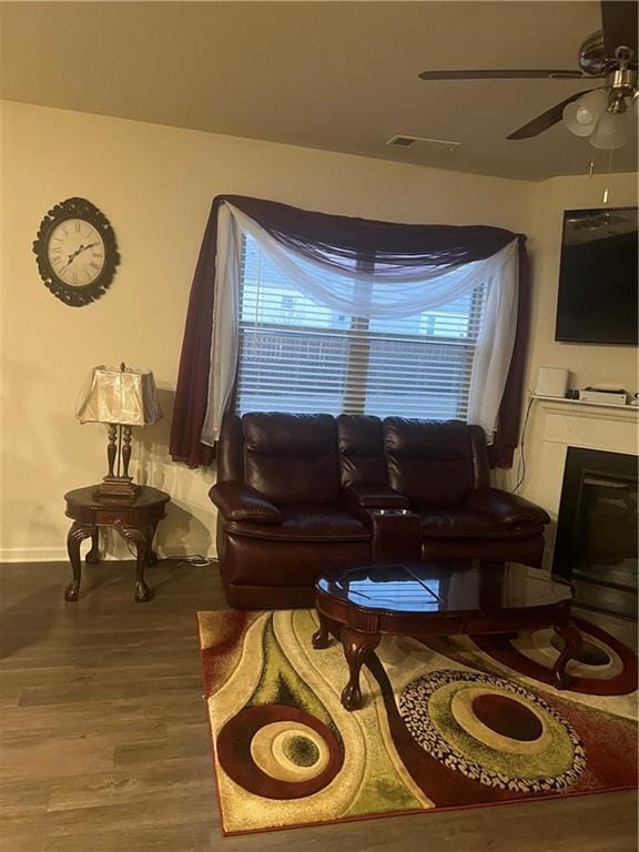 living room featuring hardwood / wood-style flooring, a healthy amount of sunlight, and ceiling fan