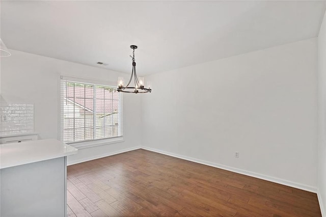 2983 Albright Commons NW, Kennesaw, GA 30144 - unfurnished dining area with dark wood finished floors and a chandelier