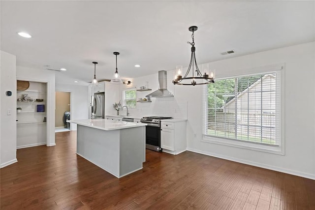 2983 Albright Commons NW, Kennesaw, GA 30144 - kitchen with wall chimney exhaust hood, appliances with stainless steel finishes, a chandelier, a center island, and white cabinets