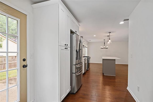 2983 Albright Commons NW, Kennesaw, GA 30144 - kitchen featuring appliances with stainless steel finishes, white cabinetry, dark wood finished floors, recessed lighting, and a chandelier