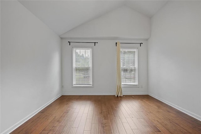2983 Albright Commons NW, Kennesaw, GA 30144 - spare room with vaulted ceiling, healthy amount of natural light, and wood finished floors