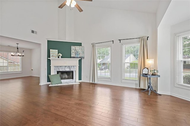 2983 Albright Commons NW, Kennesaw, GA 30144 - unfurnished living room with high vaulted ceiling, a high end fireplace, wood finished floors, a ceiling fan, and a chandelier