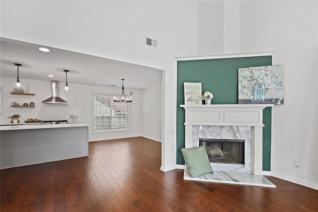 2983 Albright Commons NW, Kennesaw, GA 30144 - unfurnished living room featuring a fireplace, a chandelier, dark wood finished floors, recessed lighting, and a towering ceiling