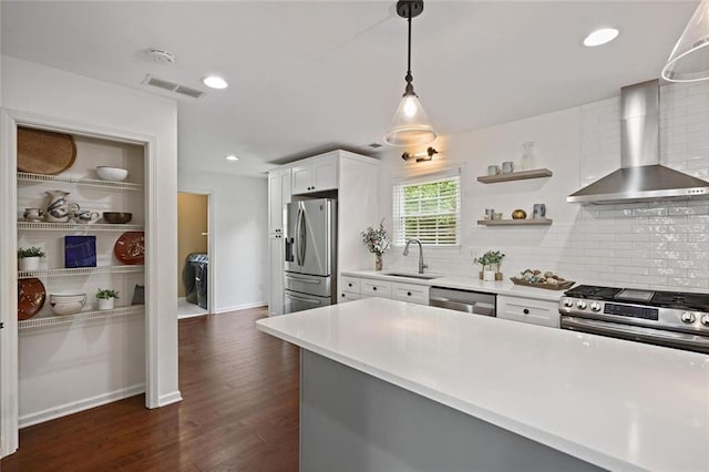 2983 Albright Commons NW, Kennesaw, GA 30144 - kitchen featuring appliances with stainless steel finishes, wall chimney exhaust hood, tasteful backsplash, white cabinets, and light countertops