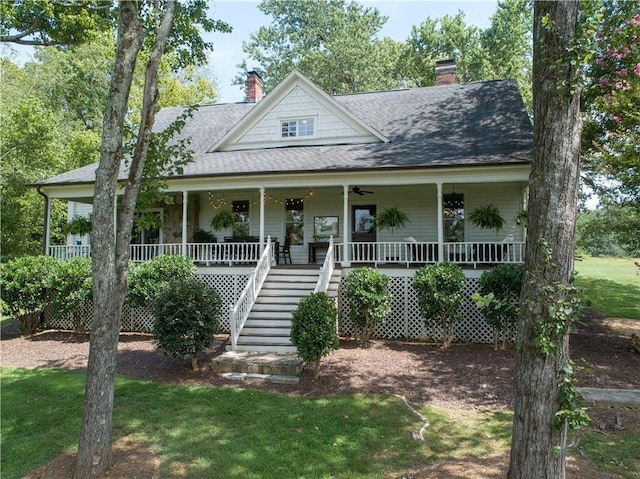 farmhouse-style home with a front lawn and covered porch