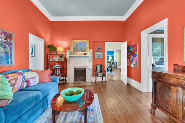 living room with hardwood / wood-style floors and ornamental molding