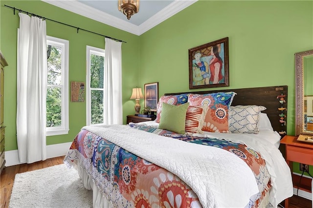 bedroom with hardwood / wood-style flooring and ornamental molding