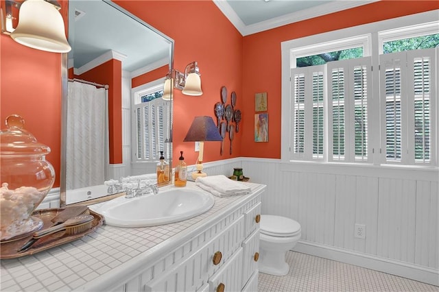 bathroom featuring crown molding, vanity, toilet, and tile patterned flooring