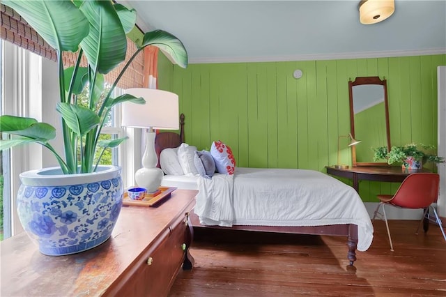 bedroom featuring crown molding and dark wood-type flooring