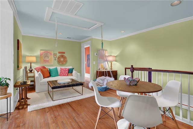 dining area with crown molding and light wood-type flooring