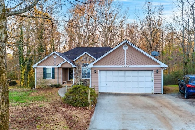 single story home featuring a garage and stone siding