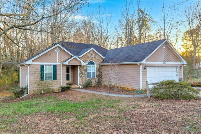 ranch-style home with an attached garage and stone siding