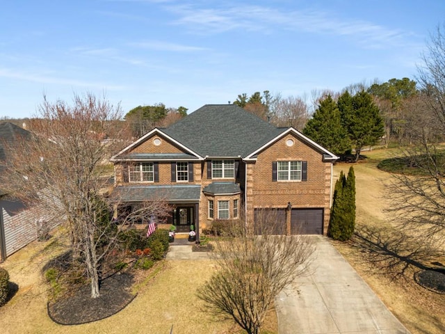 view of front facade featuring concrete driveway, brick siding, and an attached garage