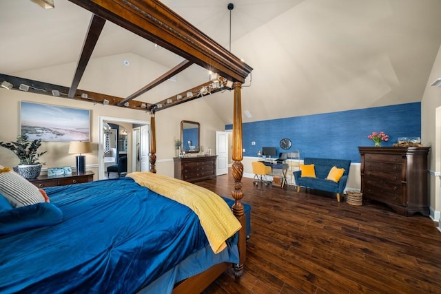 bedroom featuring lofted ceiling with beams, an accent wall, wood finished floors, baseboards, and wallpapered walls