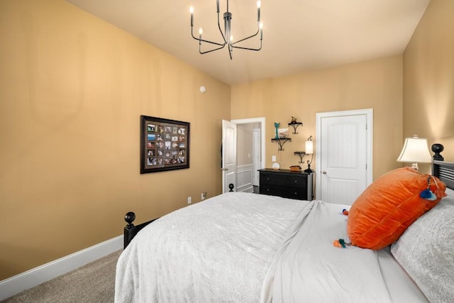 carpeted bedroom with baseboards and a notable chandelier