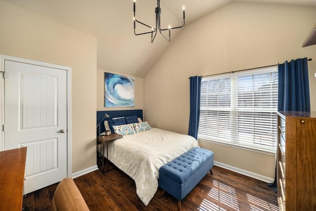 bedroom with lofted ceiling, a notable chandelier, baseboards, and wood finished floors