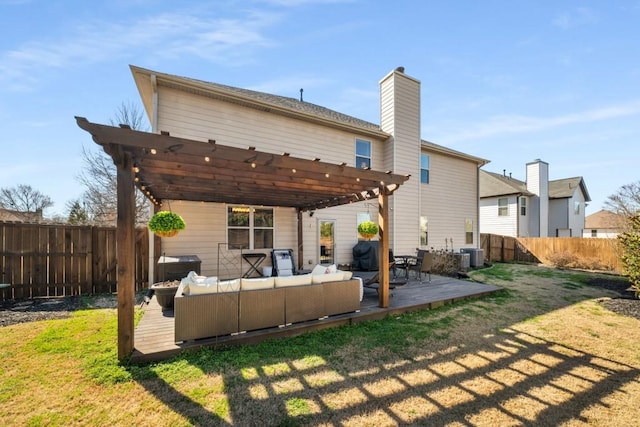 rear view of property featuring a fenced backyard, outdoor lounge area, a pergola, and a wooden deck