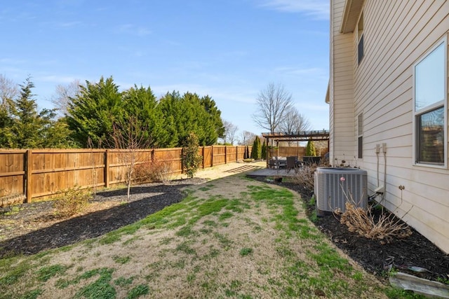 view of yard with a pergola, a fenced backyard, a patio, and central AC unit