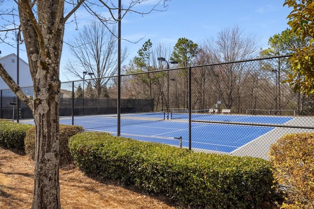 view of sport court featuring fence