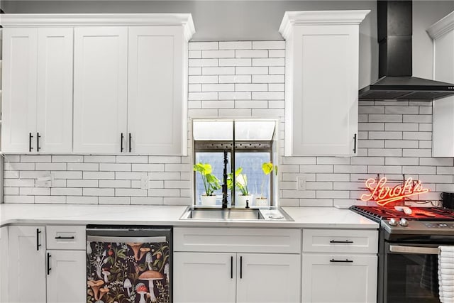 611 Pickett St SE, Atlanta, GA 30316 - kitchen featuring dishwashing machine, wall chimney range hood, stainless steel gas range oven, tasteful backsplash, and white cabinets